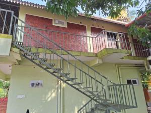 a staircase on the side of a house at Mangrove Ecostay in Gokarna