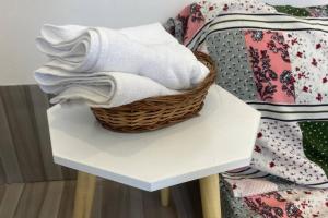a basket of towels on a table next to a chair at Budget friendly Mini Heaven 2 in Kolkata