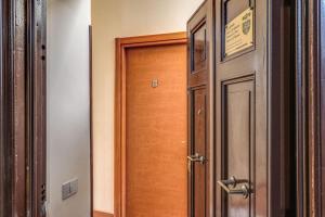a wooden door in a hallway next to a room at Locanda San Cosimato in Rome