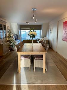 a dining room with a table and a christmas tree at Zen at Sea Duplex Blankenberge in Blankenberge +39 photos