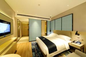 Voodi või voodid majutusasutuse Echarm Hotel Yulin Second People's Hospital Qingwanjiang Park toas