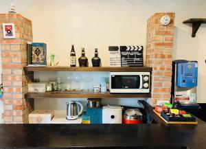 a kitchen with a counter with a microwave on a shelf at Jiuju in Jiufen