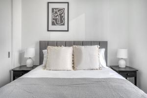 a bedroom with a bed with two nightstands and two lamps at Rincon Hill 1BR w WD Gym Pool nr Tech HQs SFO-784 in San Francisco +19 photos
