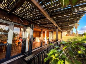 an outdoor deck with a pergola on a house at Scarborough Nature Lodge in Cape Town