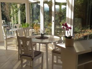 a white dining room with a table and chairs at KVINT Vendégház in Zalaegerszeg +26 photos