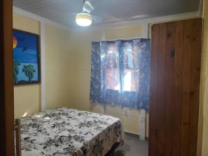 Ένα ή περισσότερα κρεβάτια σε δωμάτιο στο Casa Caminho das Dunas