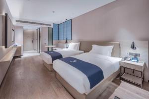 Letto o letti in una camera di Echarm Hotel Nanning East Railway Station
