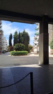 an empty parking lot with a chain in front of a building at Casa di Angela in Syracuse +14 photos