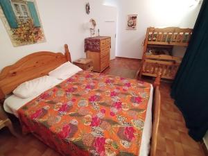 a bedroom with a bed with a colorful blanket at Mes Maisons - Holiday Villa in Drome Provencale - Villa Bellevue Venterol 26110 in Venterol