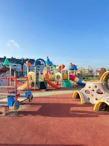 a park with a playground with a slide and slidesktop at Apartament Premium Zamkowa A14 in Tczew