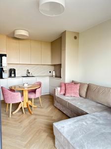 a living room with a couch and a table at Apartament Premium Zamkowa A14 in Tczew