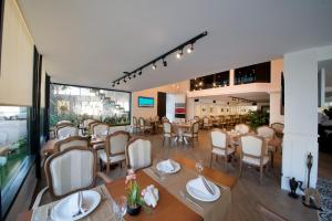 a restaurant with tables and chairs in a room at North Point Hotel in Samsun
