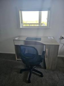 an office with a desk with a chair and a window at Private room in Wellington with views in Wellington