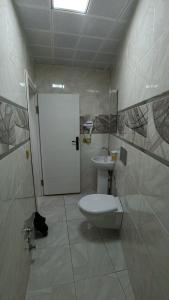 a bathroom with a toilet and a sink at ADiLOGLU PANSiYON in Uzungöl +43 photos