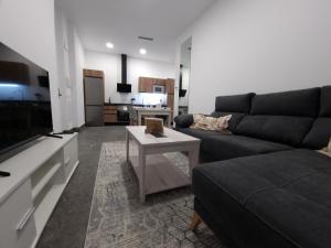 a living room with a couch and a table at CARMELO APARTAMENTo in San Jose de la Rinconada