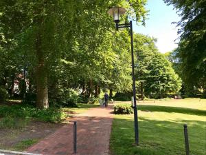 a street light on a brick path in a park at Kurpark Appartement in Glücksburg
