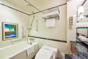 a bathroom with a toilet and a sink and a tub at Hotel New Otani Tokyo Garden Tower in Tokyo