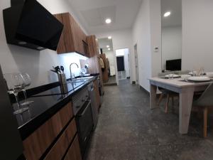 a kitchen with a sink and a table in a room at CARMELO APARTAMENTo in San Jose de la Rinconada +11 photos