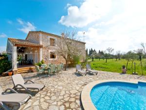 a villa with a swimming pool in front of a house at Finca Rafael in Búger