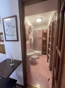 a bathroom with two toilets and a sink and a shower at Hotel Ristorante Il Principe in Claviere