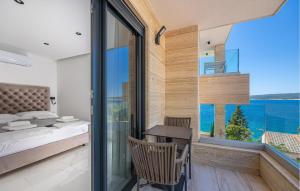 a bedroom with a bed and a view of the ocean at Awesome Apartment In Crikvenica in Crikvenica