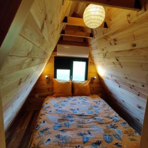a bedroom with a bed in a wooden house at Tipi Dakota des monteaux in Vivy +54 photos