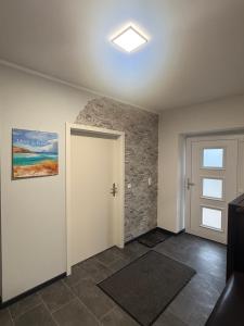 an empty room with a door and a window at Ferienwohnung Parkentin 3 in Bartenshagen-Parkentin +1 photo