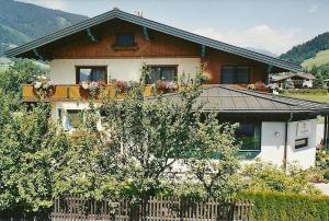 a house with a fence in front of it at Pension Wieser "Baschtlmai" in Altenmarkt im Pongau