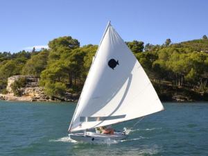 a white sailboat in the water on a lake at Château d'Esparron in Esparron-de-Verdon