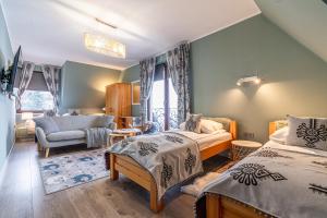 Posteľ alebo postele v izbe v ubytovaní Folkowy Dworek SPA & Fun
