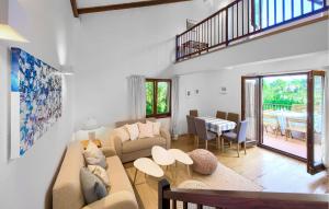 a living room with a couch and a table at Beautiful Home In Malinska With Wifi in Malinska