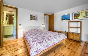 a bedroom with a bed and a wooden floor at Beautiful Home In Malinska With Wifi in Malinska