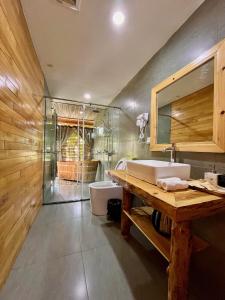 a bathroom with a sink and a toilet and a mirror at Anne House Bac Ha in Bắc Hà