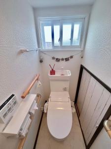 a bathroom with a white toilet with a window at 樽前の雪 in Otaru +10 photos