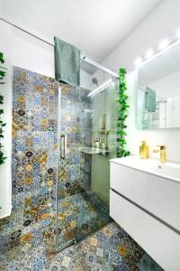 a bathroom with a shower and a sink at Urban Oasis Cismigiu in Bucharest