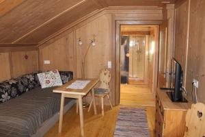 a living room with a couch and a table at Familienwanderhof Eggeler in Liesing