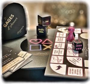 a table with a remote control and other items on it at Luxe and Spa in Condé-Sainte-Libiaire