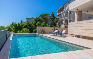 a swimming pool in the backyard of a house at Gorgeous Apartment In Crikvenica in Crikvenica +29 photos