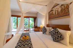 Postel nebo postele na pokoji v ubytování Narada Suite & Villa