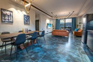 a living room with a table and chairs and a couch at Naomi Boutique Suites in Netu'a