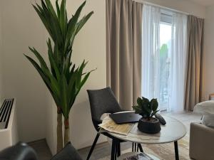 a living room with a table with a laptop on it at hotel le manoir in Gostivar