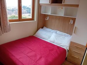 a small bed in a small room with a window at Terrasses D 306 PARC NAT VANOISE appart 6 pers in Val Cenis