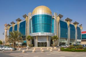 a large glass building with a gold dome on it at RAND by Wandalus in Riyadh