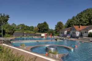 a large swimming pool with people in the water at kirchheim 119 in Kirchheim