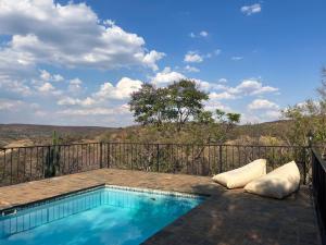a swimming pool on the balcony of a house at Kunkura Game Lodge & Conference Centre in Modimolle
