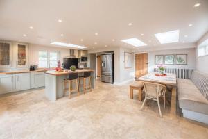 a kitchen with a table and a dining room at Buoys Cottage, Orford in Orford