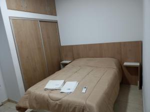 a bed in a room with two towels on it at Espacio Millán in Concepción del Uruguay