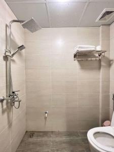 a bathroom with a shower and a toilet at NINE HOUSING 290 Kim Ma in Hanoi