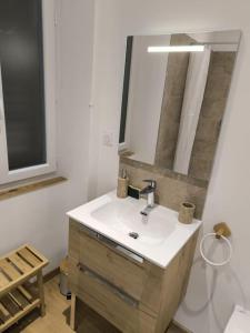 a bathroom with a sink and a mirror at Sublime 3 p au centre-ville in Saint-Martin-Vésubie +10 photos