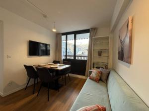 a living room with a couch and a table at RPP A115 - Skis aux pieds, 4 pers, 2 chambres in Tignes